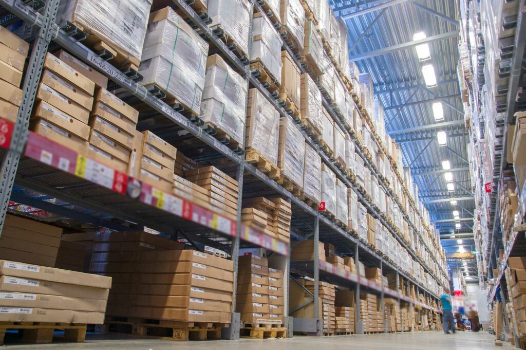 Inside a busy Warehouse with pallets stacked on shelving