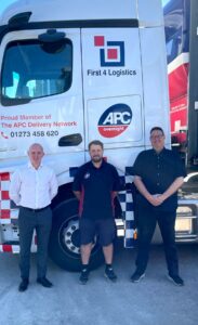 First 4 Logistics Staff in front of HGV Lorry
