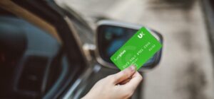 UK Fuels Card in a persons hand by a vehicle
