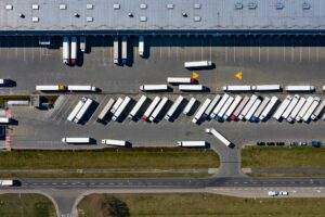 overhead view of a logistics warehouse with HGV trucks in the transport loading bays
