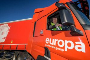 a politician sitting in the drivers seat of a large red lorry