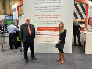 Bill Hockin representing RHA Members hands over a cheque to Caroline from Transaid