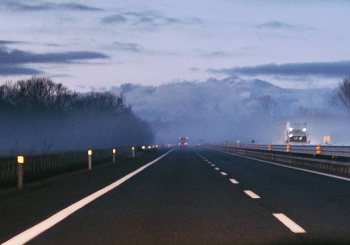 Courier driving on empty motorway during coronavirus lockdown