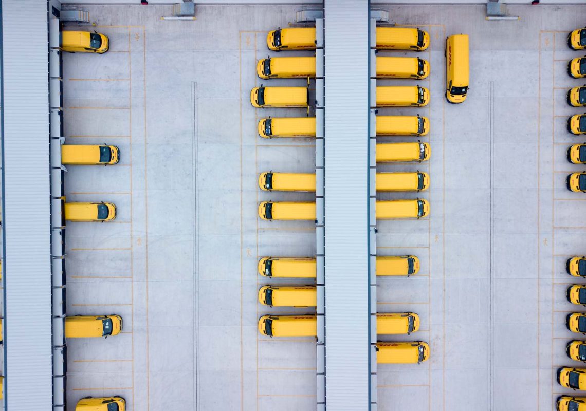 Overhead drone shot of DHL Express Vans at loading bays