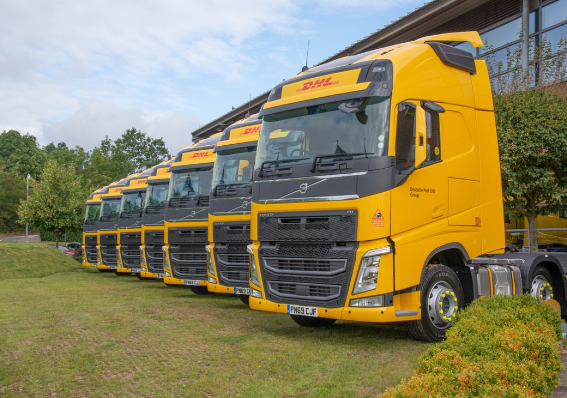 A row of DHL Trucks that use HVO in a line