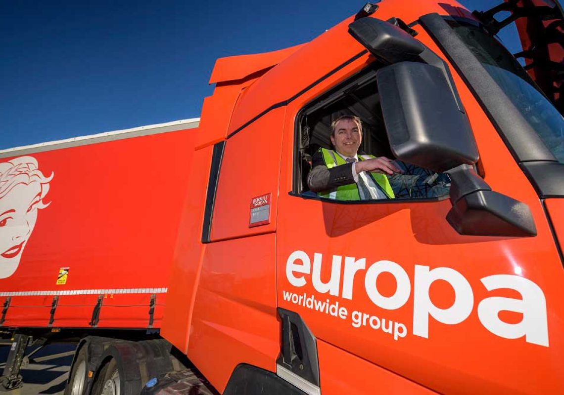 a politician sitting in the drivers seat of a large red lorry
